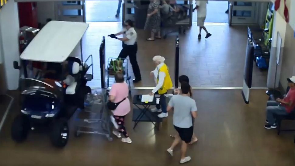 A golf cart is seen traveling through the glass front doors of a Walmart store in Gibsonton, Florida, on Thursday afternoon. The golf cart struck some customers before crashing into the cash register area, deputies said. (Screen capture from video provided by Hillsborough County Sheriff)