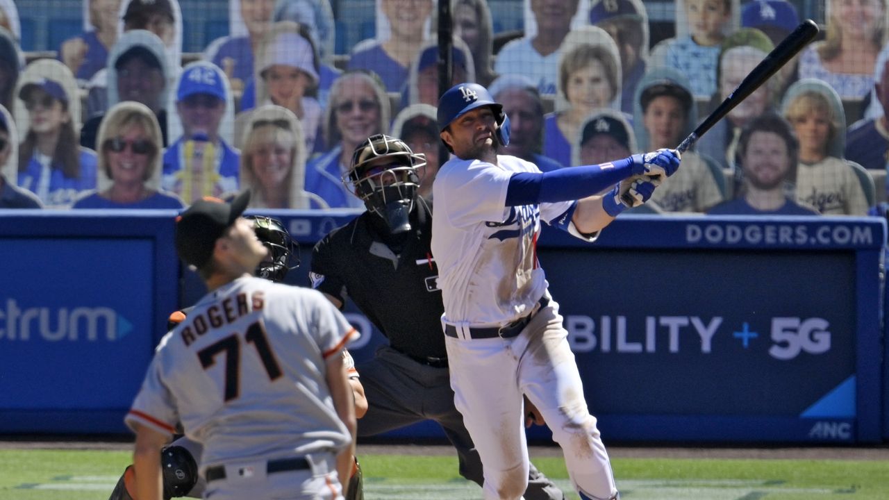 Los Angeles Dodgers' AJ Pollock watches his three-run home run off San Francisco Giants relief pitcher Tyler Rogers, foreground, during the seventh inning of a baseball game Sunday, Aug. 9, 2020, in Los Angeles. (AP Photo/Mark J. Terrill)
