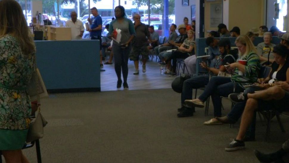 People waiting and sitting in chairs at a Texas Drivers License Office. 