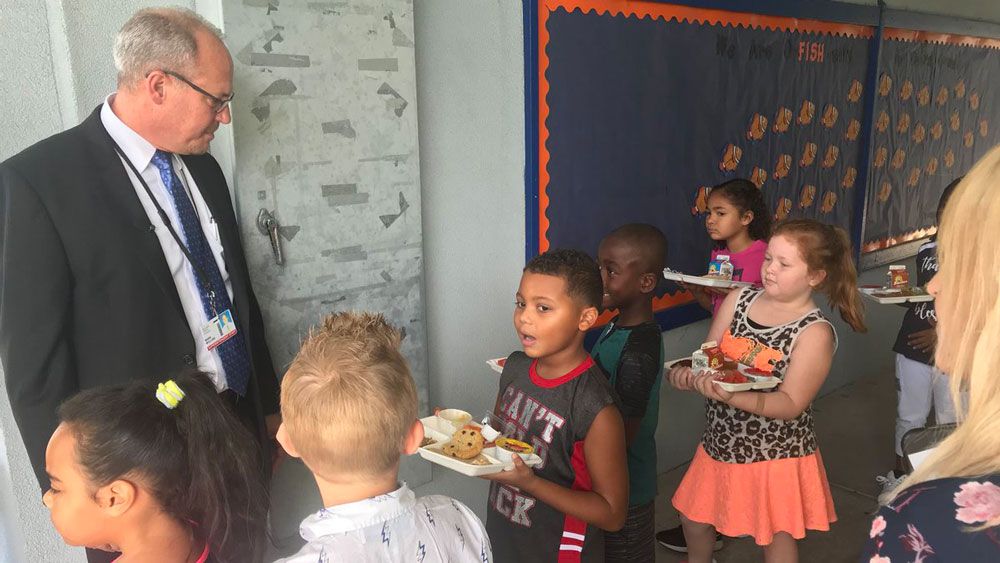 Dr. Mark Mullins, the new superintendent, meets Brevard County students on the first day of school. (Greg Pallone, Staff)