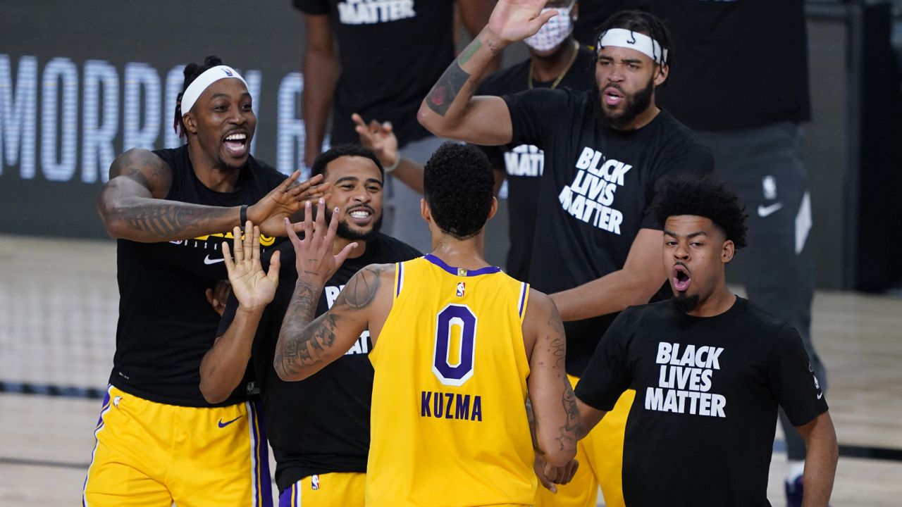 Los Angeles Lakers' Kyle Kuzma (0) is congratulated by teammates after hitting a game-winning 3-pointer against the Denver Nuggets during the second half of an NBA basketball game Monday, Aug. 10, 2020, in Lake Buena Vista, Fla. The Lakers won 124-121. (Ashley Landis/AP)