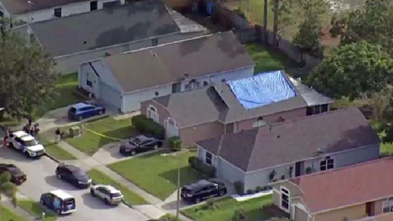 The body of a man was found in a freshly dug hole behind an Orlando house Friday. (Sky 13)