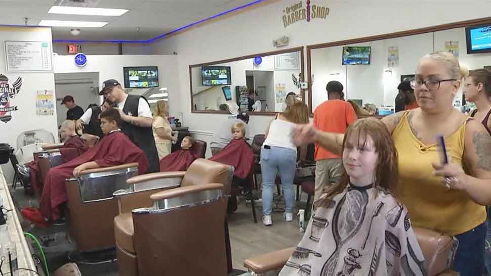 Children receiving free haircuts at The Original BarberShop in New Port Richey as part of Rising Stars of Tampa Bay's 7th Annual End of Summer Bash, Sunday, August 11, 2019. (Ashley Paul/Spectrum Bay News 9)