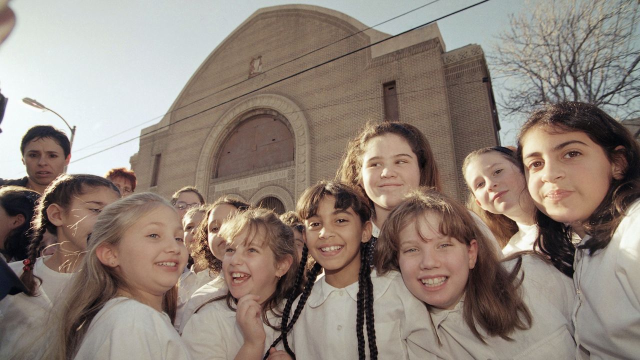 Third, fourth and fifth graders from the Valley Beth Shalom choir sing outside the Breed Street Shul after first lady Hillary Rodham Clinton announced a $1.1 million dollar grant to the National Trust for Historic Preservation at a public ceremony in Los Angeles, Thursday, Dec. 10, 1998. (AP Photo/Reed Saxon)