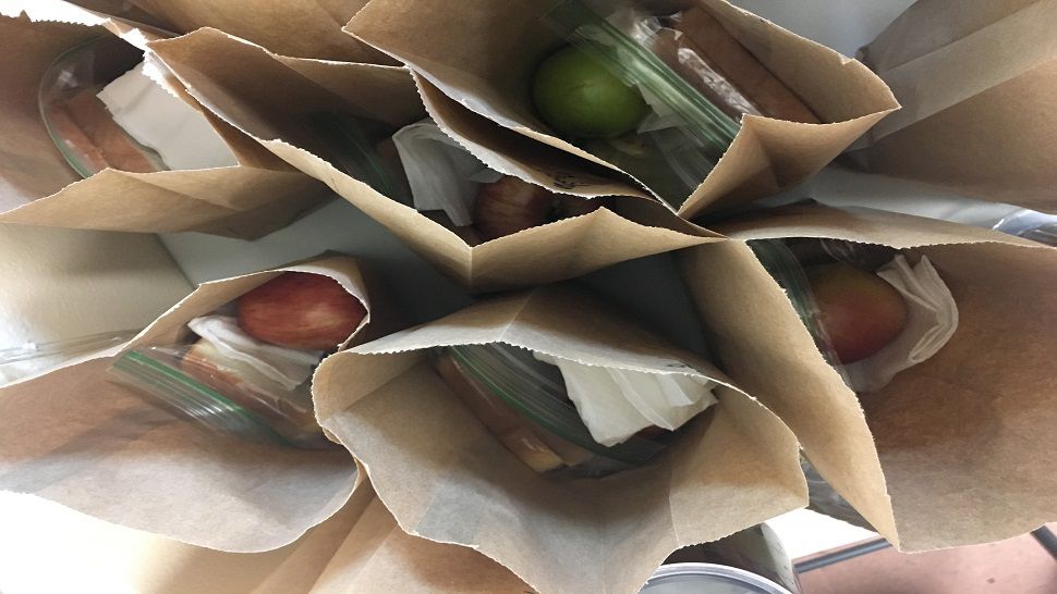 Sandwiches, salads, and sweets are packed into lunch bags with a lot of love in the kitchen at "Father and Son Love Worship Centre” in Lutz.