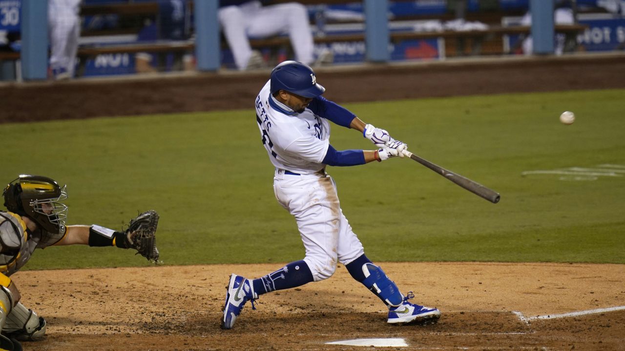 Los Angeles Dodgers' Mookie Betts hits his third home run of a baseball game during the fifth inning against the San Diego Padres, Thursday, Aug. 13, 2020, in Los Angeles. (AP Photo/Jae C. Hong)
