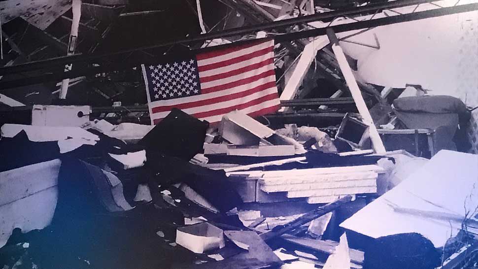 An American flag hung up over ruins of a building in Punta Gorda destroyed by Hurricane Charley in 2004.