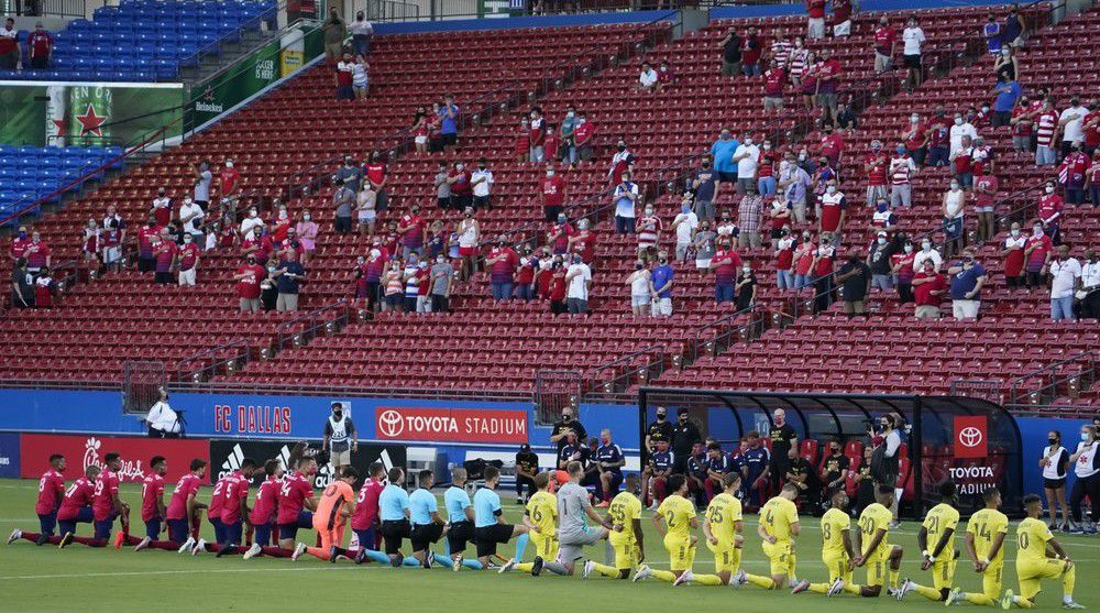 FC Dallas (left) and Nashville SC players kneel during the national anthem before an MLS soccer game at Toyota Stadium on Wednesday, Aug. 12, 2020, in Frisco, Texas. (Smiley N. Pool/The Dallas Morning News via AP)