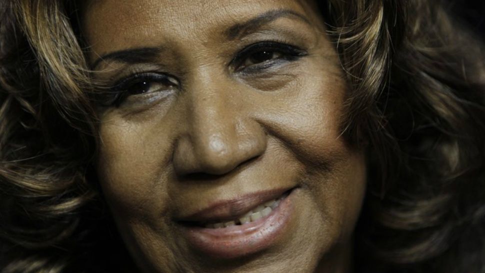 In this Feb. 11, 2011 file photo, Aretha Franklin smiles after the Detroit Pistons-Miami Heat NBA basketball game in Auburn Hills, Mich. (AP Photo/Paul Sancya, File)