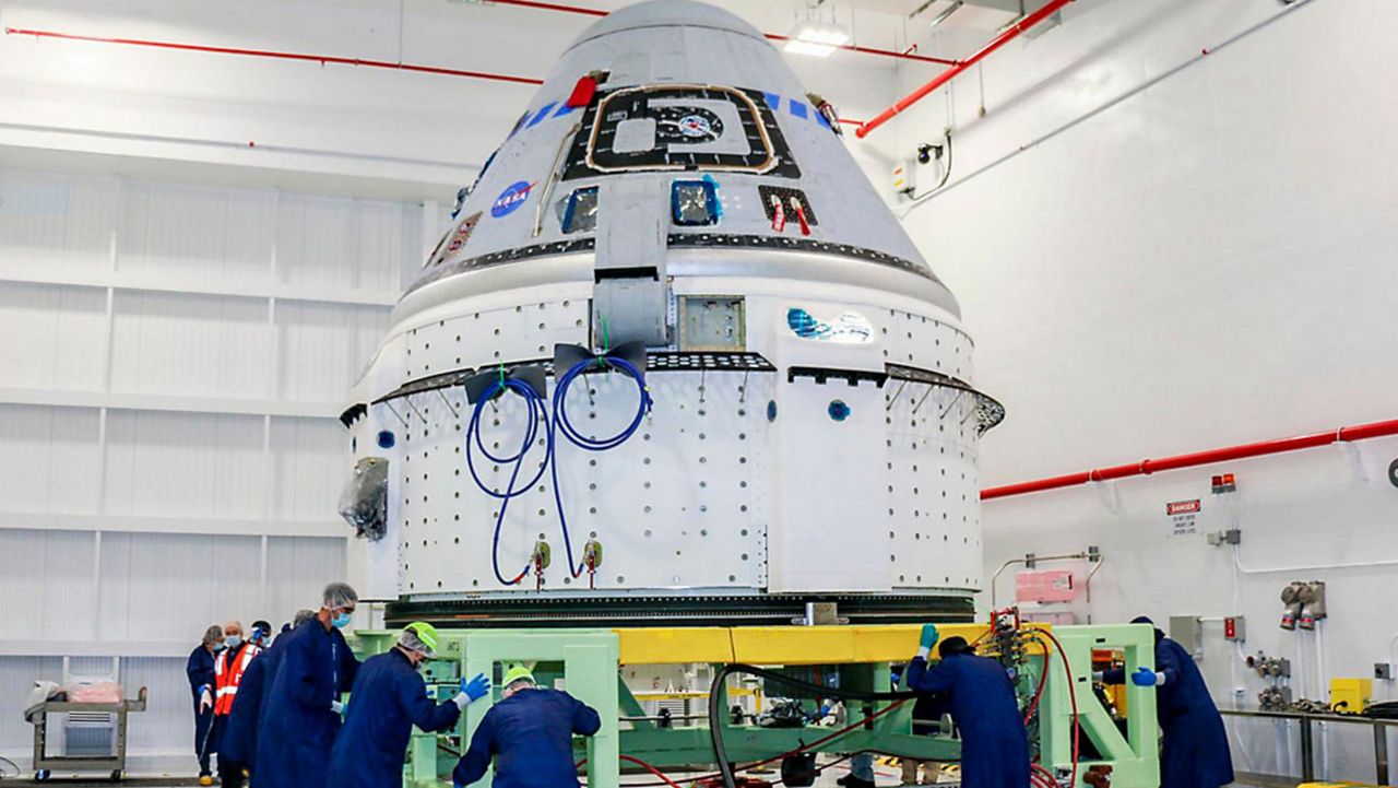 Boeing and NASA officials said the Starliner capsule, shown in June above, is grounded for months and possibly even until next year because of a valve problem.  (NASA via AP)