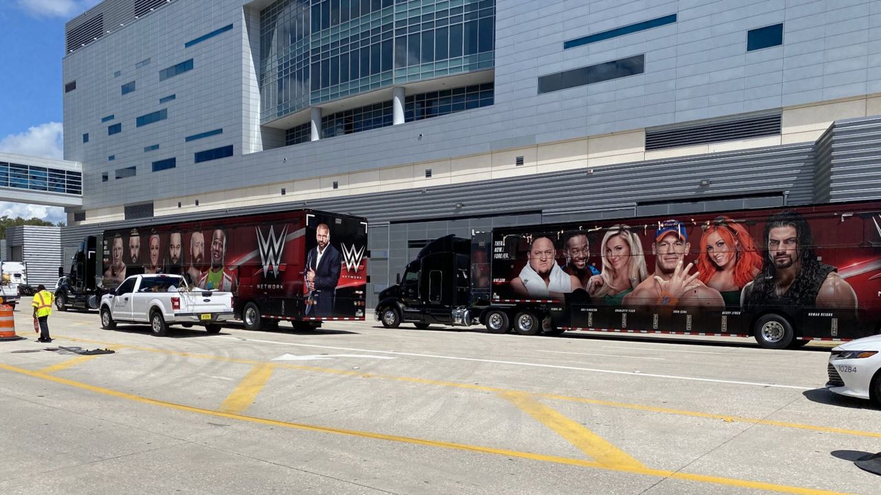 WWE trucks are seen being unloaded outside the Amway Center in downtown Orlando on Friday, August 14, 2020. (Jon Alba/Spectrum News)