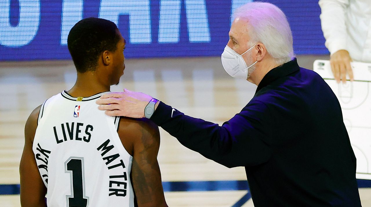 San Antonio Spurs head coach Gregg Popovich, right, talks with Lonnie Walker IV (1) during the first quarter of an NBA basketball game against the Utah Jazz, Thursday, Aug. 13, 2020, in Lake Buena Vista, Fla. (Kevin C. Cox/Pool Photo via AP)