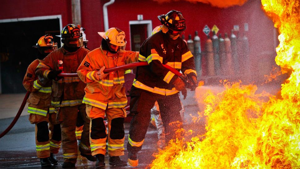 FILE photo of firefighters fighting a fire. 
