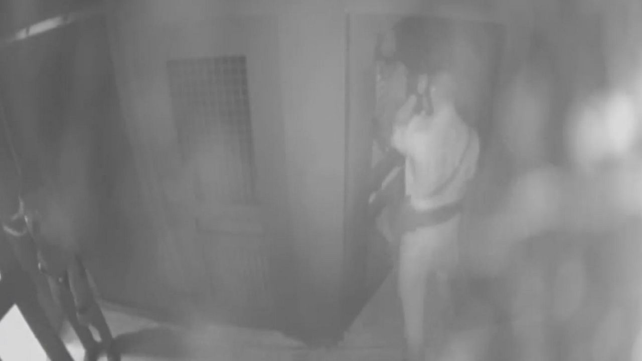 Screen grab from video showing Deputy Louis Valentin punching an inmate in the face. (Manatee County Sheriff's Office)