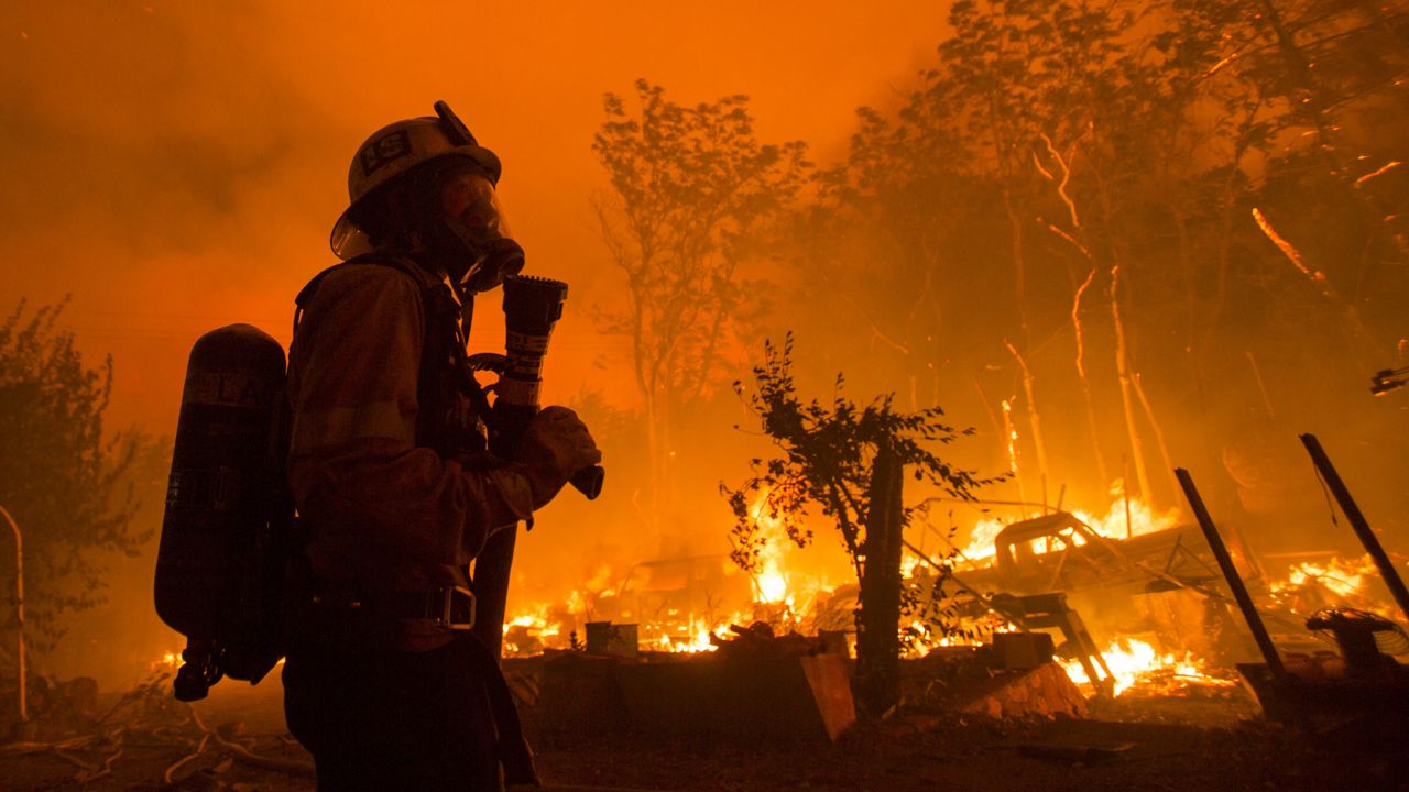 A firefighter watches the Lake Hughes fire in Angeles National Forest on Wednesday, Aug. 12, 2020, north of Santa Clarita, Calif. Firefighters continued to battle an out-of-control wildfire Sunday near Lake Hughes that has consumed 18,361 acres. (Ringo H.W. Chiu/AP)