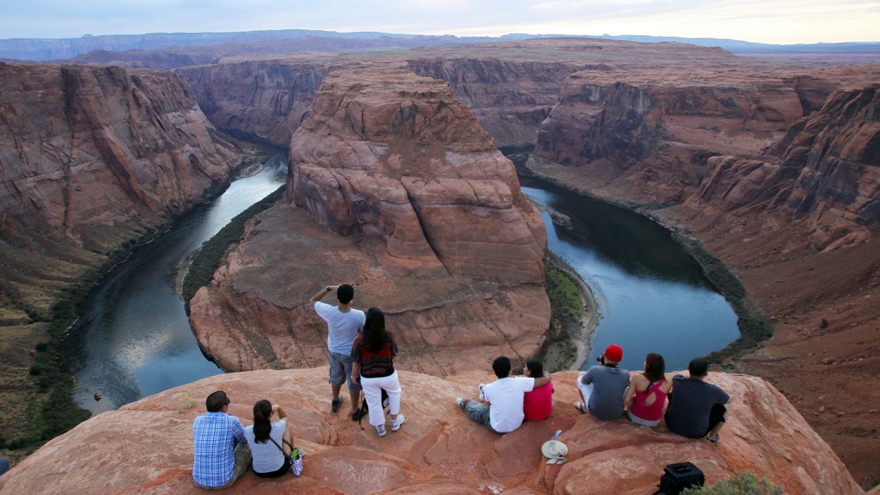 Visitors view the dramatic bend in the Colorado River at the popular Horseshoe Bend in Glen Canyon National Recreation Area, in Page, Ariz.(AP Photo/Ross D. Franklin)