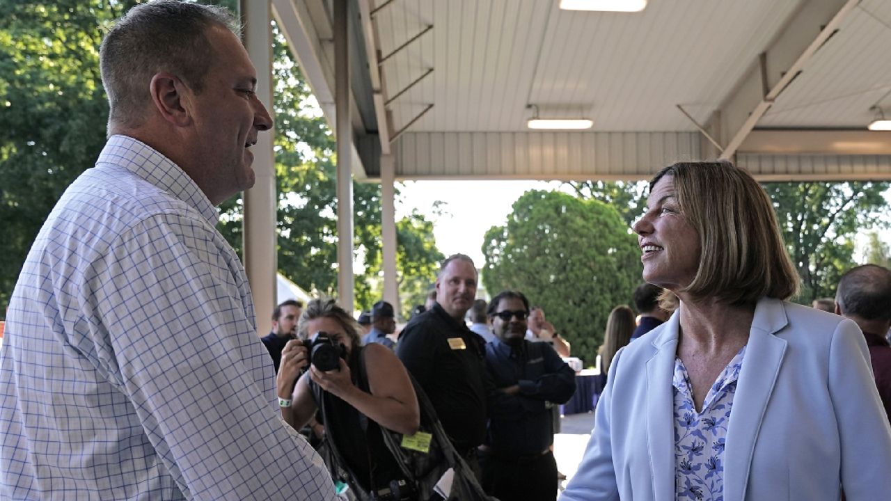 Republican U.S. Senate candidate and Missouri Attorney General Eric Schmitt and Democratic U.S. Senate candidate Trudy Busch Valentine greet each other during the Governor's Ham Breakfast at the Missouri State Fair in Sedalia, Mo. Thursday, Aug. 18, 2022. (AP Photo/Charlie Riedel)