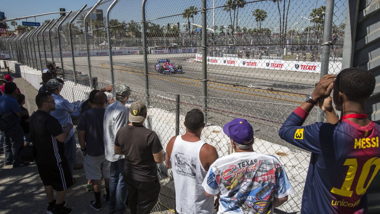 Race fans watch during practice for the IndyCarToyota Grand Prix of Long Beach auto race Friday, April 19, 2013, in Long Beach Calif. (AP Photo/Ringo H.W. Chiu)