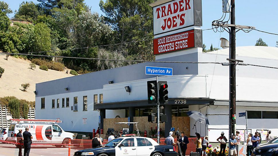 Police officers guard the entrance to the Trader Joe's Los Feliz store, as it remains closed for business, Sunday, July 22, 2018, in Los Angeles. (AP Photo/Damian Dovarganes)