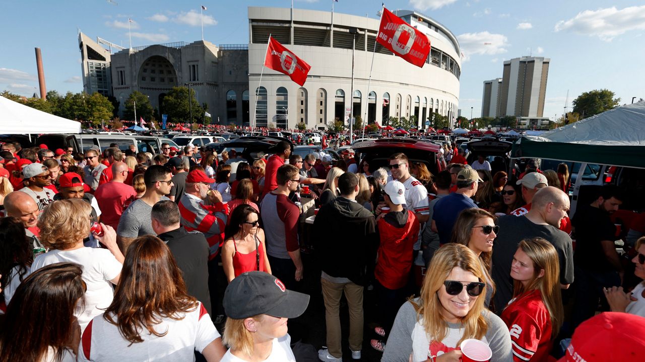 A crowd of people tailgating outside Ohio Stadium