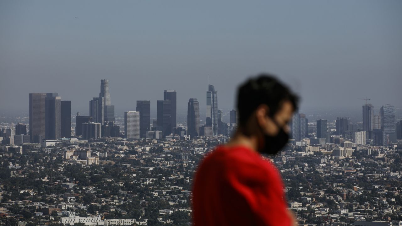 Izzy Galvan, 20, wears a face mask while visiting the Griffith Observatory overlooking downtown Los Angeles, Wednesday, July 15, 2020, in Los Angeles. (Jae C. Hong/AP)