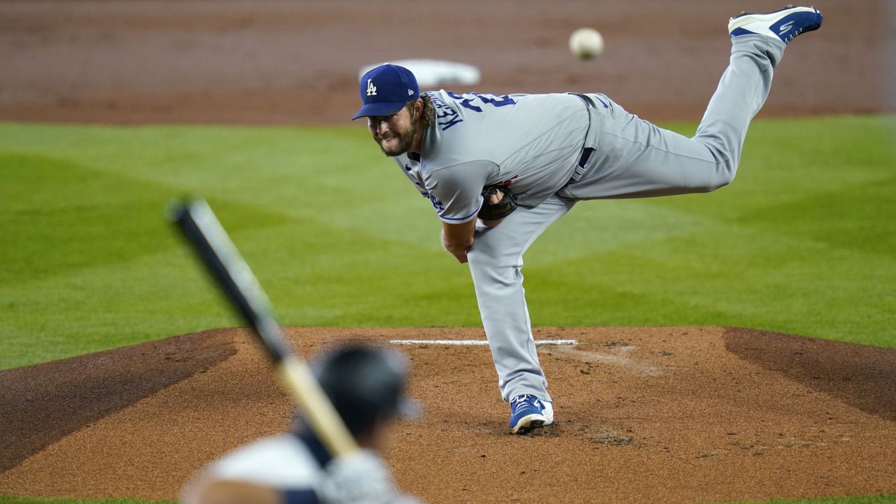 Los Angeles Dodgers starting pitcher Clayton Kershaw, top, throws against Seattle Mariners' Dylan Moore in the first inning of a baseball game Thursday, Aug. 20, 2020, in Seattle. (Elaine Thompson/AP)
