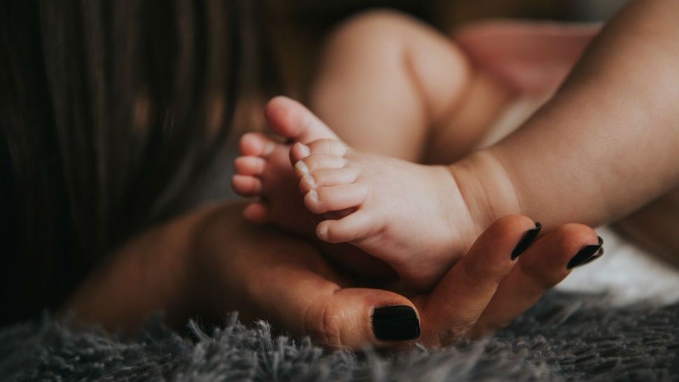 FILE photo of baby feet held in a mother's hand. 