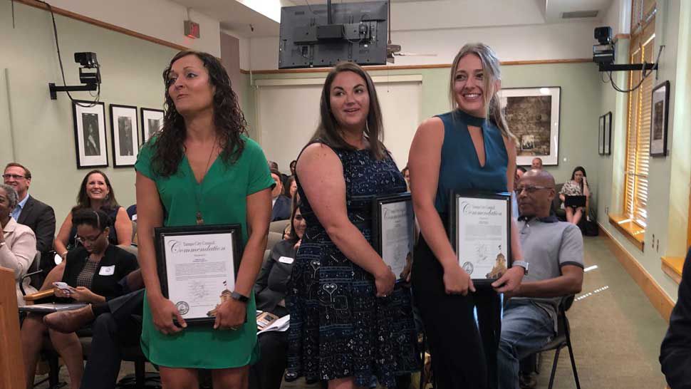 (L to r:) Tampa city employees Ashley St. Clair, Victoria Mattie, and Sophie Seidenberg each received commendations from the Tampa City Council for their efforts in rescuing a teenage boy from the Hillsborough River in July. (Dalia Dangerfield/Spectrum Bay News 9)