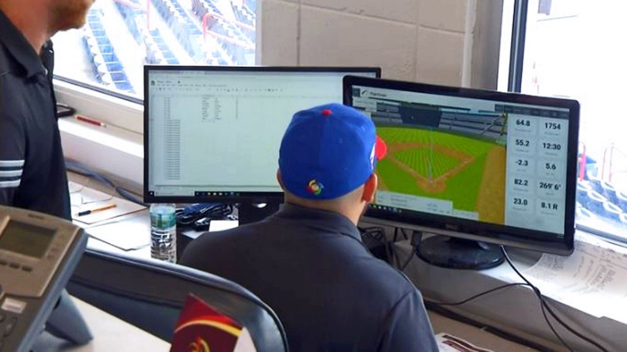 Representatives from Orlando-based 'FlightScope' are operating a portable baseball radar, which records both pitching and hitting data. (Spectrum News image)