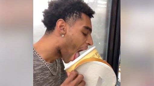 Video still frame of man licking ice cream (Dapper Don / Facebook)