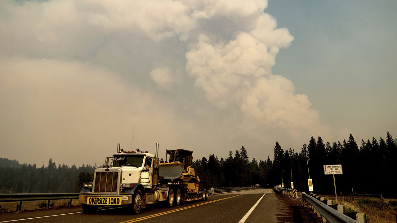 A smoke plume rises from the Dixie Fire as it approaches Lake Almanor in Plumas County, Calif., on Tuesday, Aug. 3, 2021. (AP Photo/Noah Berger)