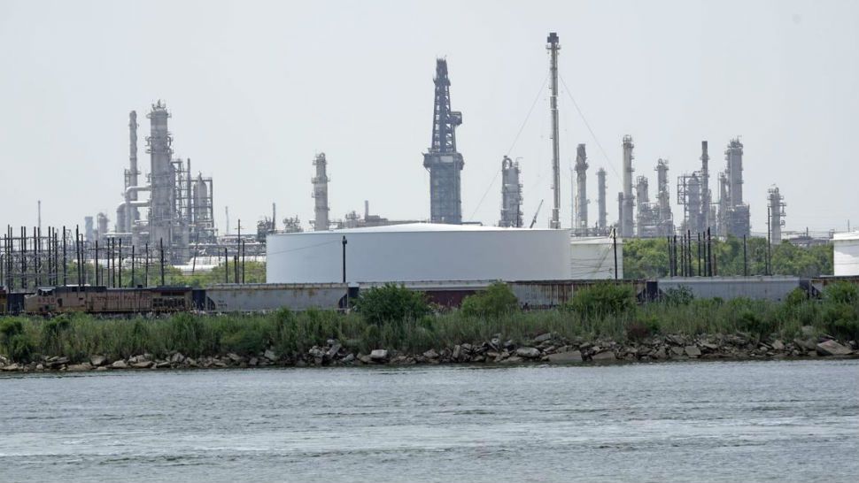 Storage tanks at a refinery along the waterway are shown Thursday, July 26, 2018, in Port Arthur, Texas. The oil industry wants the government to help protect some of its facilities on the Texas Gulf Coast against the effects of global warming. One proposal involves building a nearly 60-mile “spine” of flood barriers to shield refineries and chemical plants. Many Republicans argue that such projects should be a national priority. But others question whether taxpayers should have to protect refineries in a state where top politicians still dispute whether climate change is real. (AP Photo/David J. Phillip)