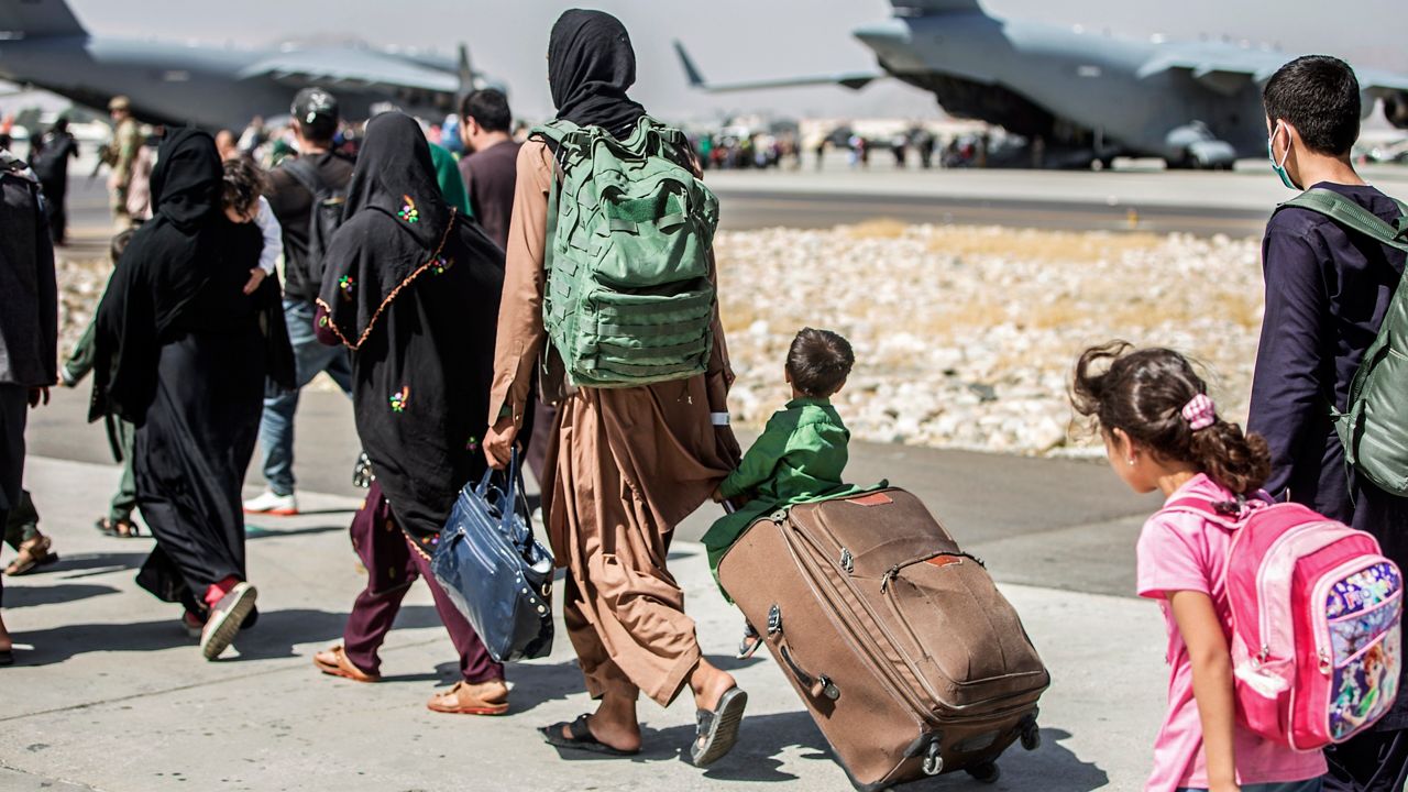 Families walk towards their flight during evacuations on Aug. 24, 2021 at Hamid Karzai International Airport, in Kabul, Afghanistan (Sgt. Samuel Ruiz/U.S. Marine Corps via AP, File)