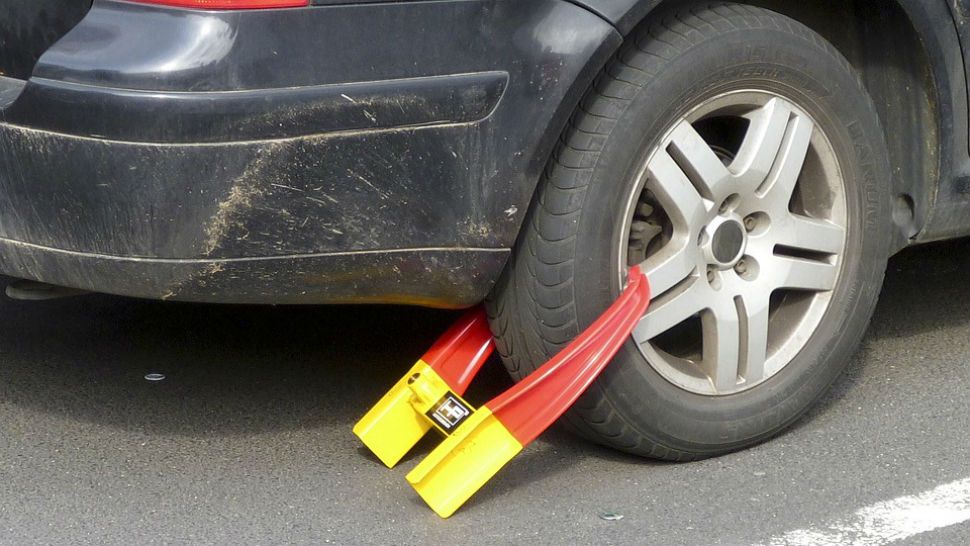 FILE photo of a car booted for parking illegally. 
