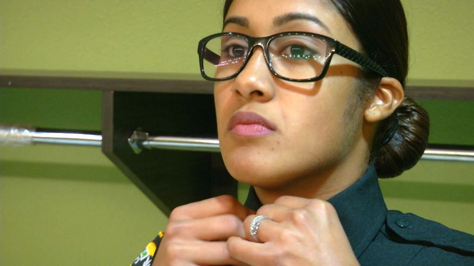 Zuheidy Nieves-Fred prepares for her pinning ceremony Thursday night at the Osceola County Sheriff's Office. Her father was a law enforcement officer in Puerto Rico for almost 30 years, and she dreamed of following in her dad's footsteps.