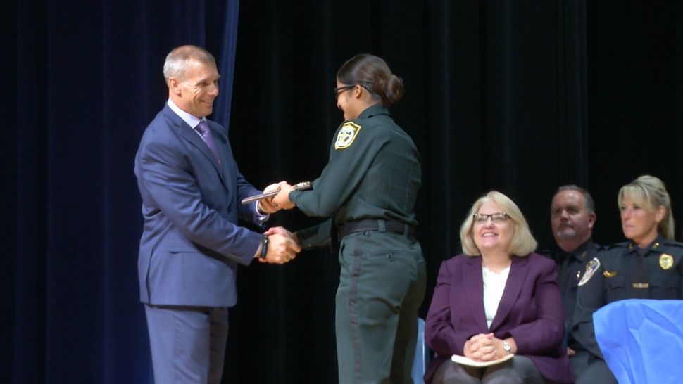 Zuheidy Nieves-Fred attends her pinning ceremony Thursday night at the Osceola County Sheriff's Office. Her father was a law enforcement officer in Puerto Rico for almost 30 years, and she dreamed of following in her dad's footsteps.