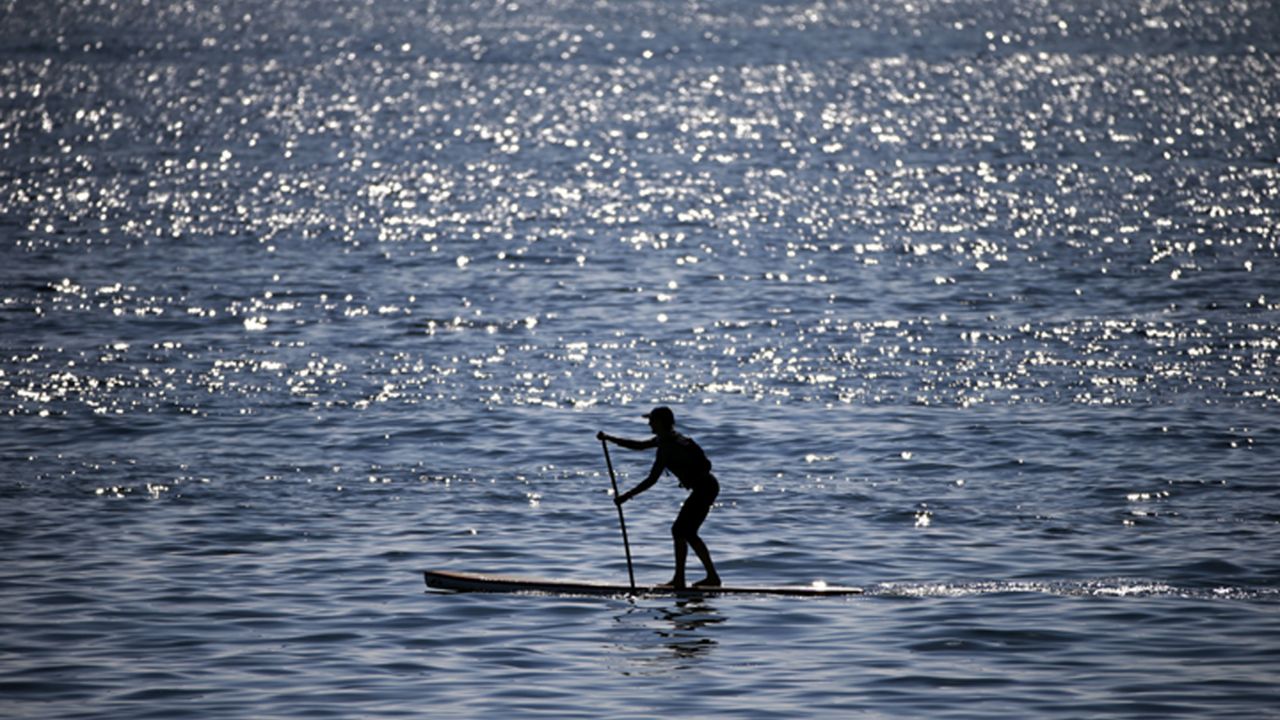 A stand-up paddler floats on the ocean near Cabrillo Beach in the San Pedro district of Los Angeles on Feb. 17, 2015. (AP Photo/Jae C. Hong)