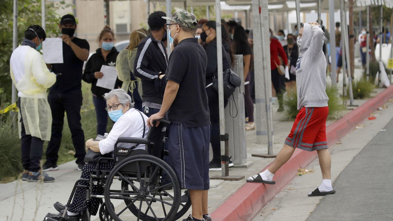 In this July 22, 2020 photo, people line up at a mobile Coronavirus testing site at the Charles Drew University of Medicine and Science in Los Angeles. (Marcio Jose Sanchez/AP)