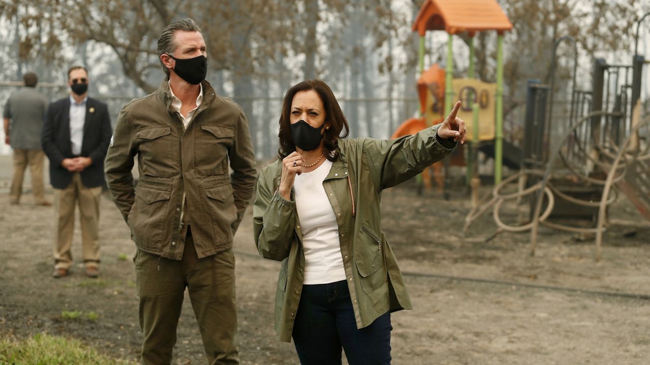California Gov. Gavin Newsom, left, and then Democratic vice presidential candidate Sen. Kamala Harris talk as they asses the damage during the Creek Fire at Pine Ridge Elementary in Auberry, Calif. on Sept. 15, 2020. (AP Photo/Gary Kazanjian)