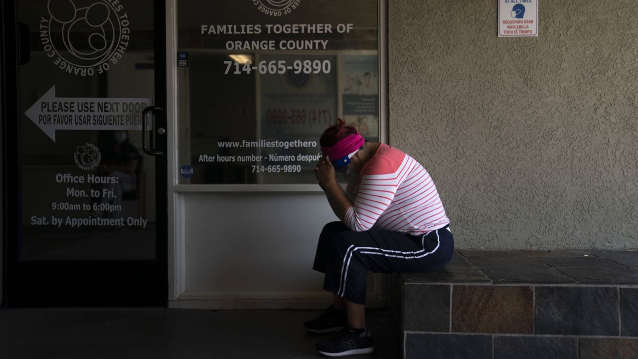 Ana Aguirre, 50, who said she was experiencing COVID-19 symptoms, waits to get tested for the virus at Families Together of Orange County Thursday, Aug. 26, 2021, in Tustin, Calif. (AP Photo/Jae C. Hong)