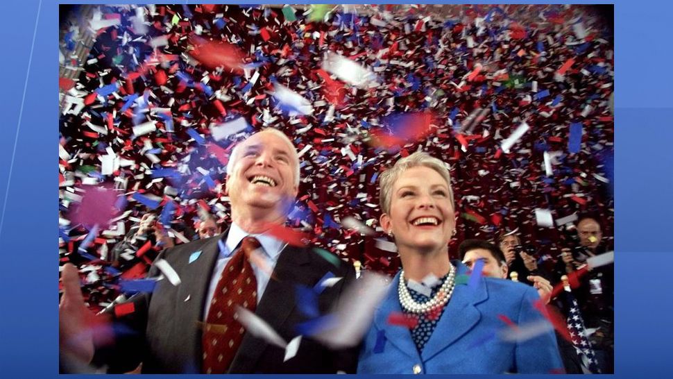 FILE - In this Jan. 30, 2000, file photo, confetti falls on Republican presidential hopeful Sen. John McCain, R-Ariz., and his wife, Cindy, at the end of their 114th New Hampshire town hall meeting with voters at the Peterborough Town House in Peterborough, N.H. Aide says senator, war hero and GOP presidential candidate McCain died Saturday, Aug. 25, 2018. He was 81. (AP Photo/Stephan Savoia, File)