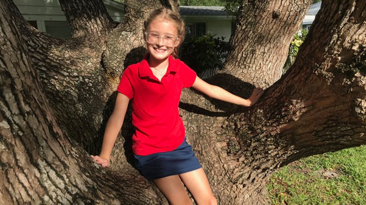 This is Kenlee, sitting in the crook of one of her trees in front of her Manatee County home. Kenlee is a new 4th grader and will be 10 soon. She says school is going okay and there are a lot of changes, but her teachers are making her feel safe- especially Mr. Averso. (Virginia Johnson/Spectrum Bay News 9)