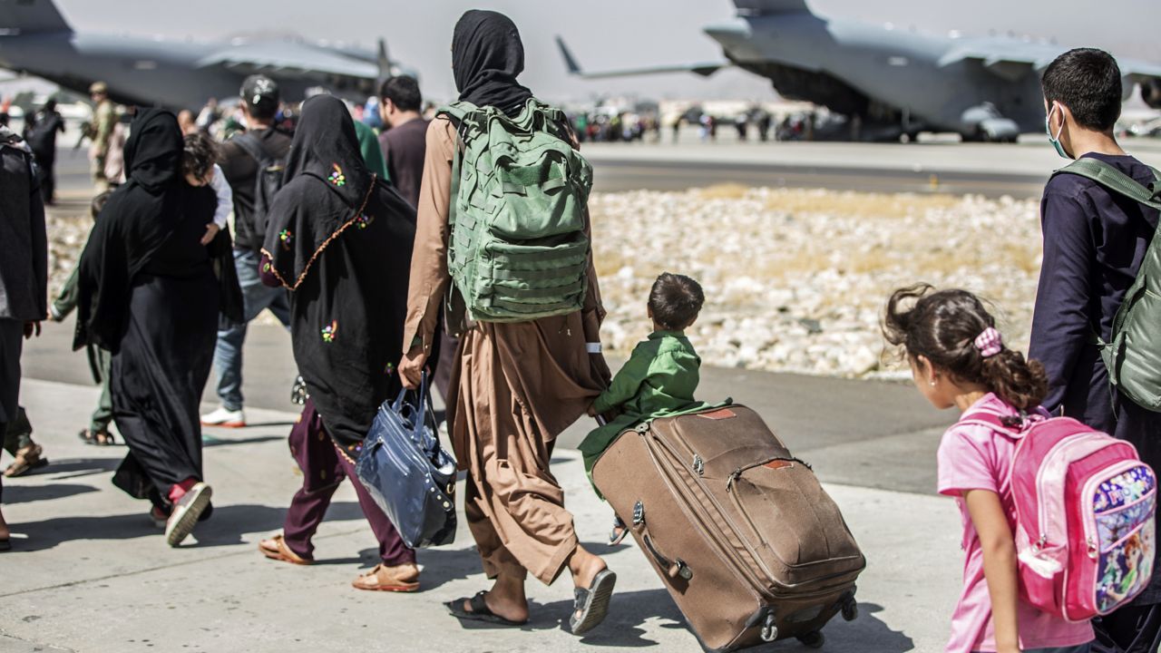 Families walk towards their flight during ongoing evacuations at Hamid Karzai International Airport, in Kabul, Afghanistan on Aug. 24, 2021. (Sgt. Samuel Ruiz/U.S. Marine Corps via AP) 