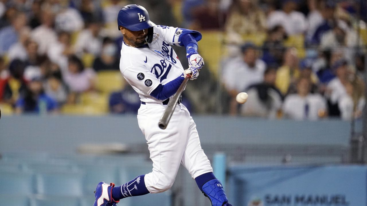 Los Angeles Dodgers' Mookie Betts connects for a solo home run during the fourth inning of the team's baseball game against the Atlanta Braves on Tuesday, Aug. 31, 2021, in Los Angeles. (AP Photo/Marcio Jose Sanchez)