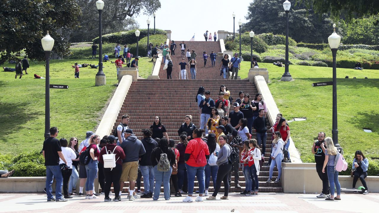 People move about the campus of the University of California, Los Angeles Friday, April 26, 2019. (AP Photo/Reed Saxon)