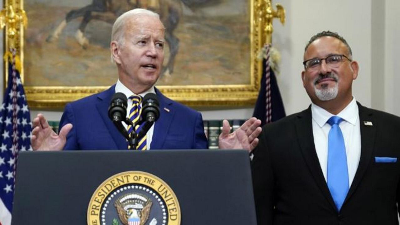 President Joe Biden, with Education Secretary Miguel Cardona at right, discusses student loan debt forgiveness in the Roosevelt Room of the White House on Aug. 24, 2022. ((AP Photo/Evan Vucci, File)