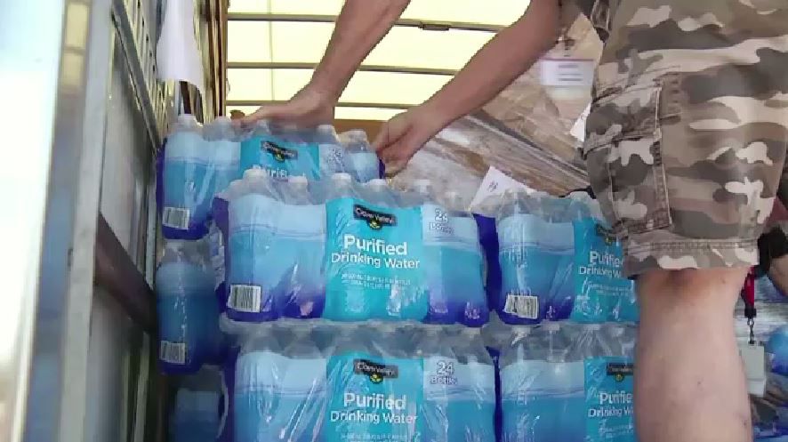 Man loading bottled water (Spectrum News file)