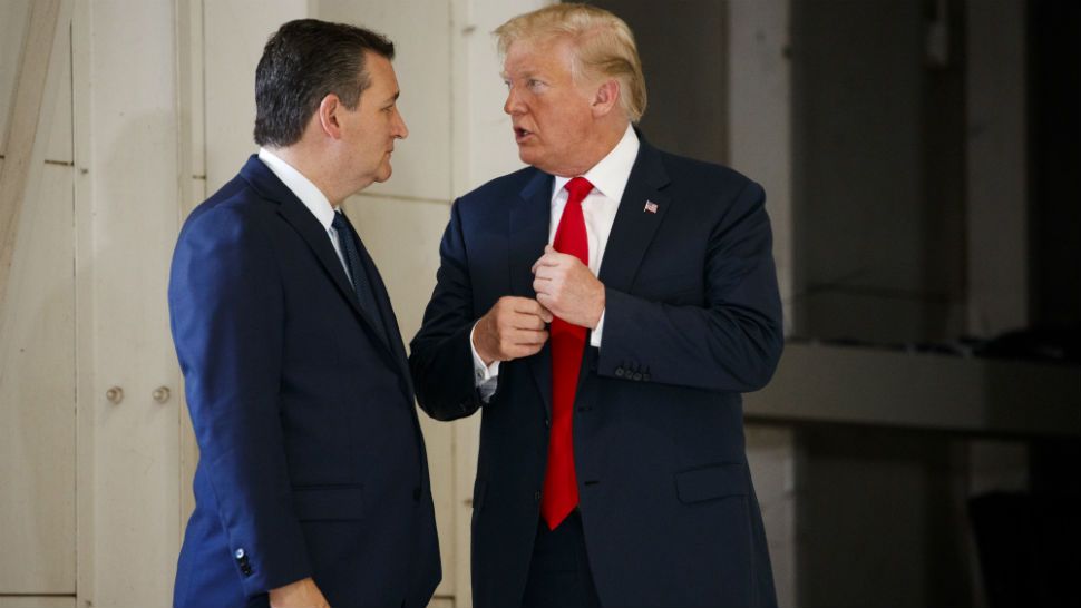 Sen. Ted Cruz talks with President Donald Trump before a meeting with families of the Santa Fe school shooting at Coast Guard Air Station Houston, Thursday, May 31, 2018, in Houston. (AP Photo/Evan Vucci)