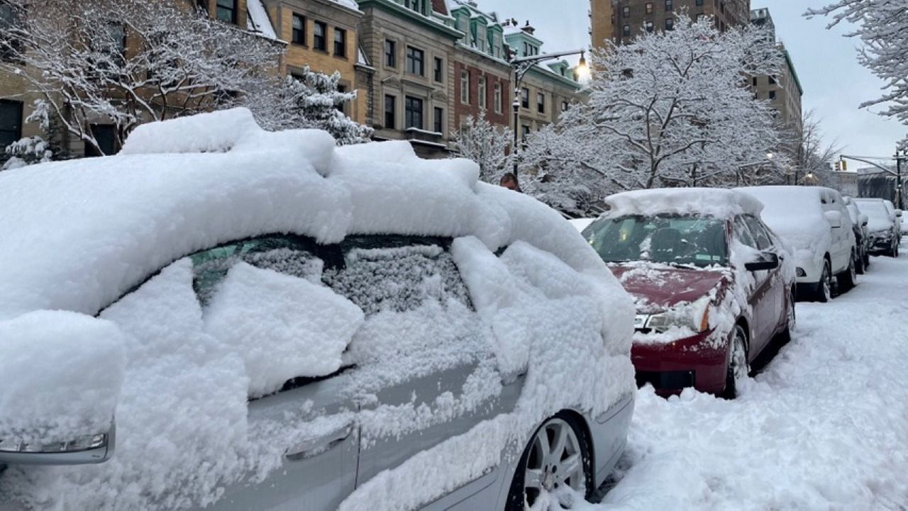 Cars are covered with snow in the city on Saturday, Feb. 17, 2024.