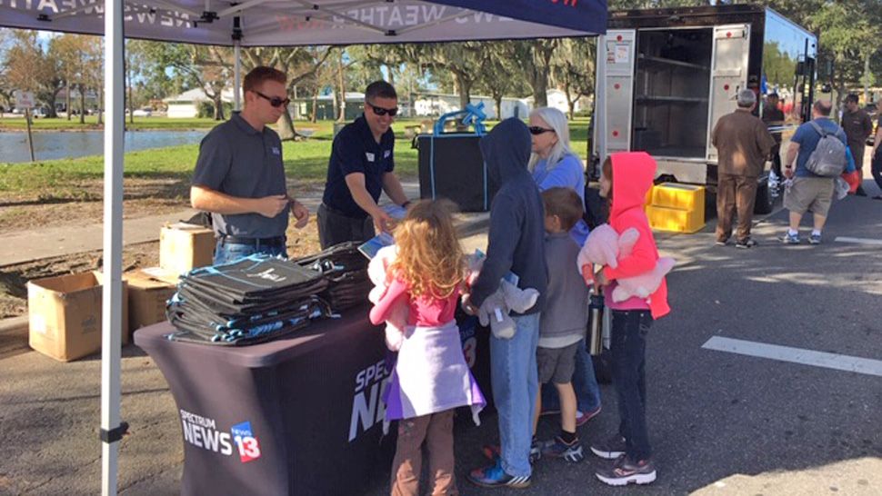 Spectrum News 13 reporter Asher Wildman and Chief Meteorologist Bryan Karrick greeted guests while photographer Ruben Almeida showed the live truck to kids who took the mic.  
